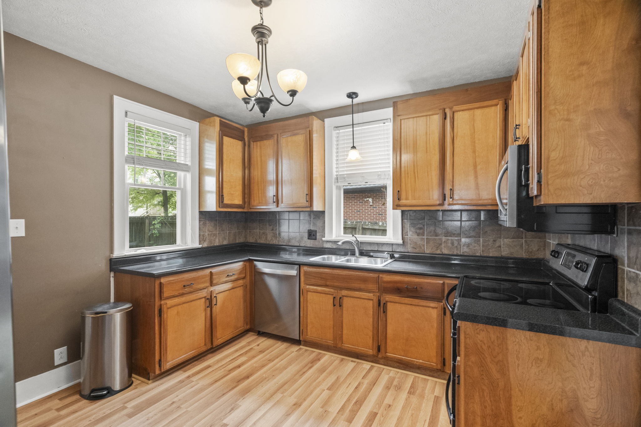 400 Connell Street Springfield, TN 37172 - Photo 6 of 53 a kitchen with stainless steel appliances granite countertop wooden cabinets a stove a sink and dishwasher next to a window