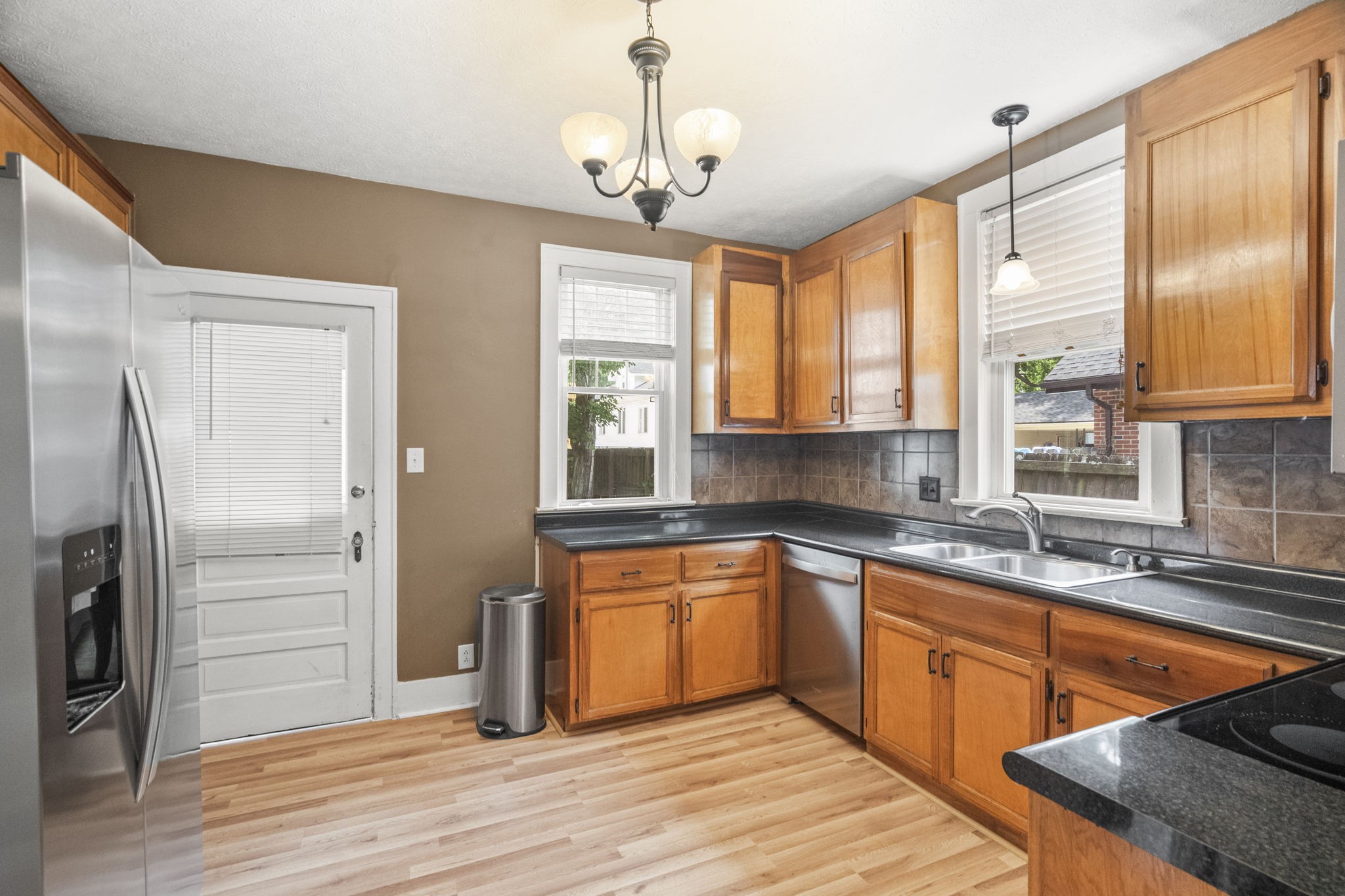 400 Connell Street Springfield, TN 37172 - Photo 7 of 53 a kitchen with stainless steel appliances granite countertop a refrigerator a sink dishwasher a stove and white countertops with wooden floor