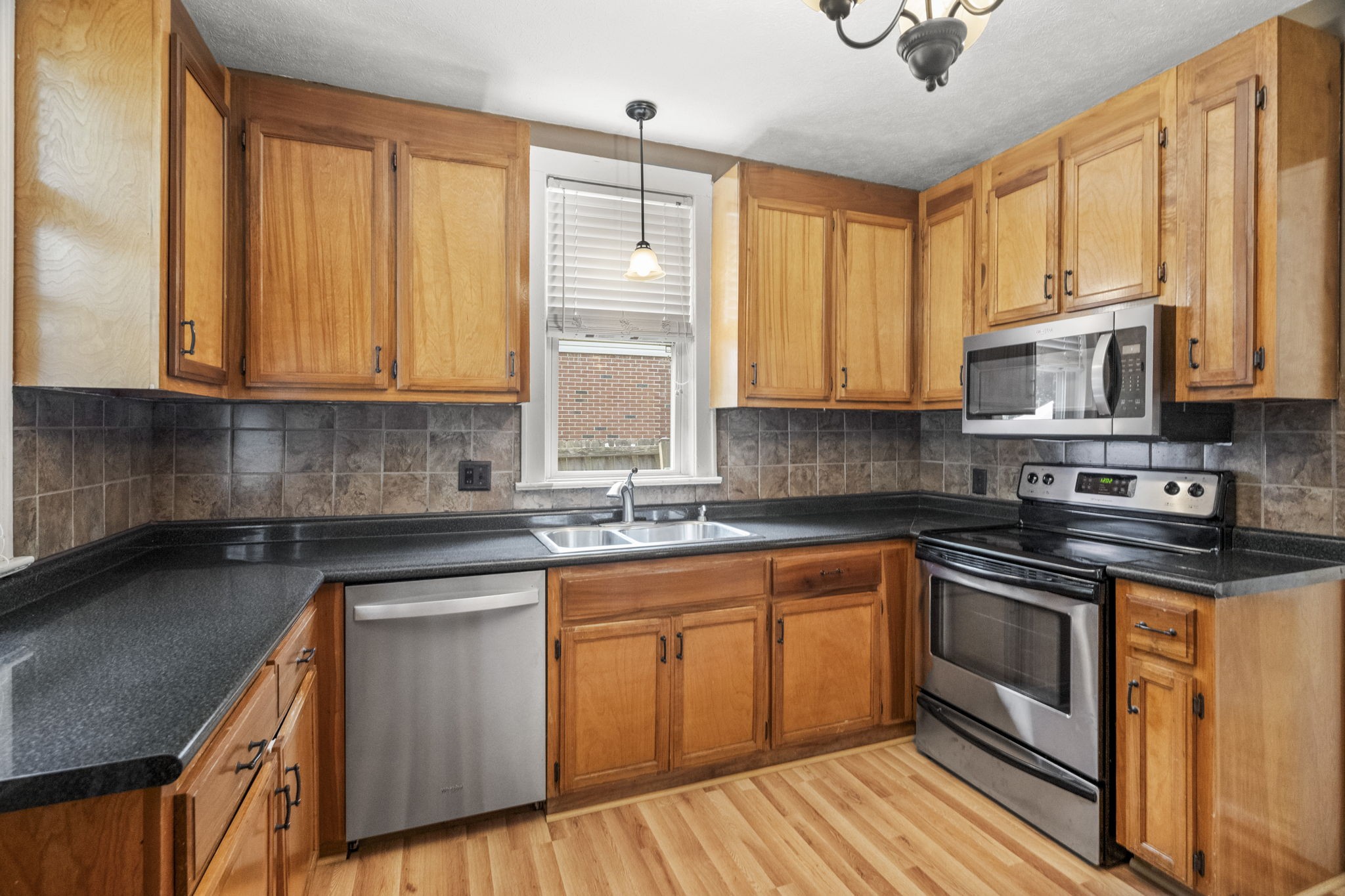 400 Connell Street Springfield, TN 37172 - Photo 9 of 53 a kitchen with stainless steel appliances granite countertop wooden cabinets a sink and a stove