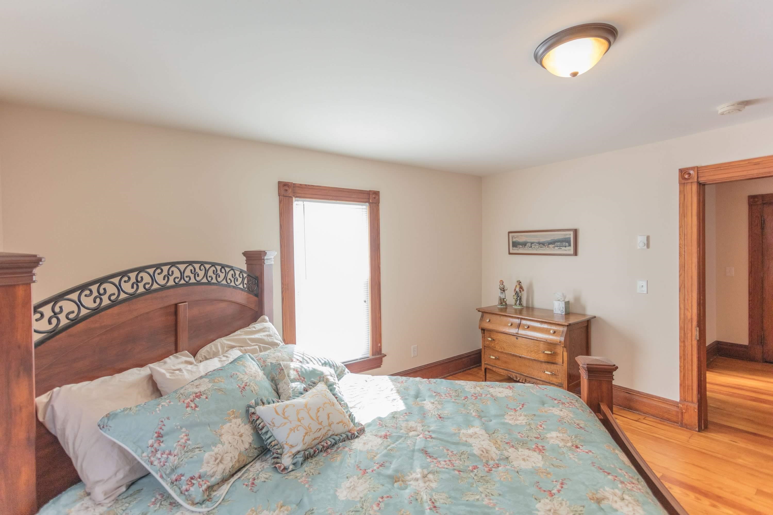 11 Shady Lane Raphine, VA 24472 - Photo 30 of 41 a bedroom with a bed and a dresser with potted plants