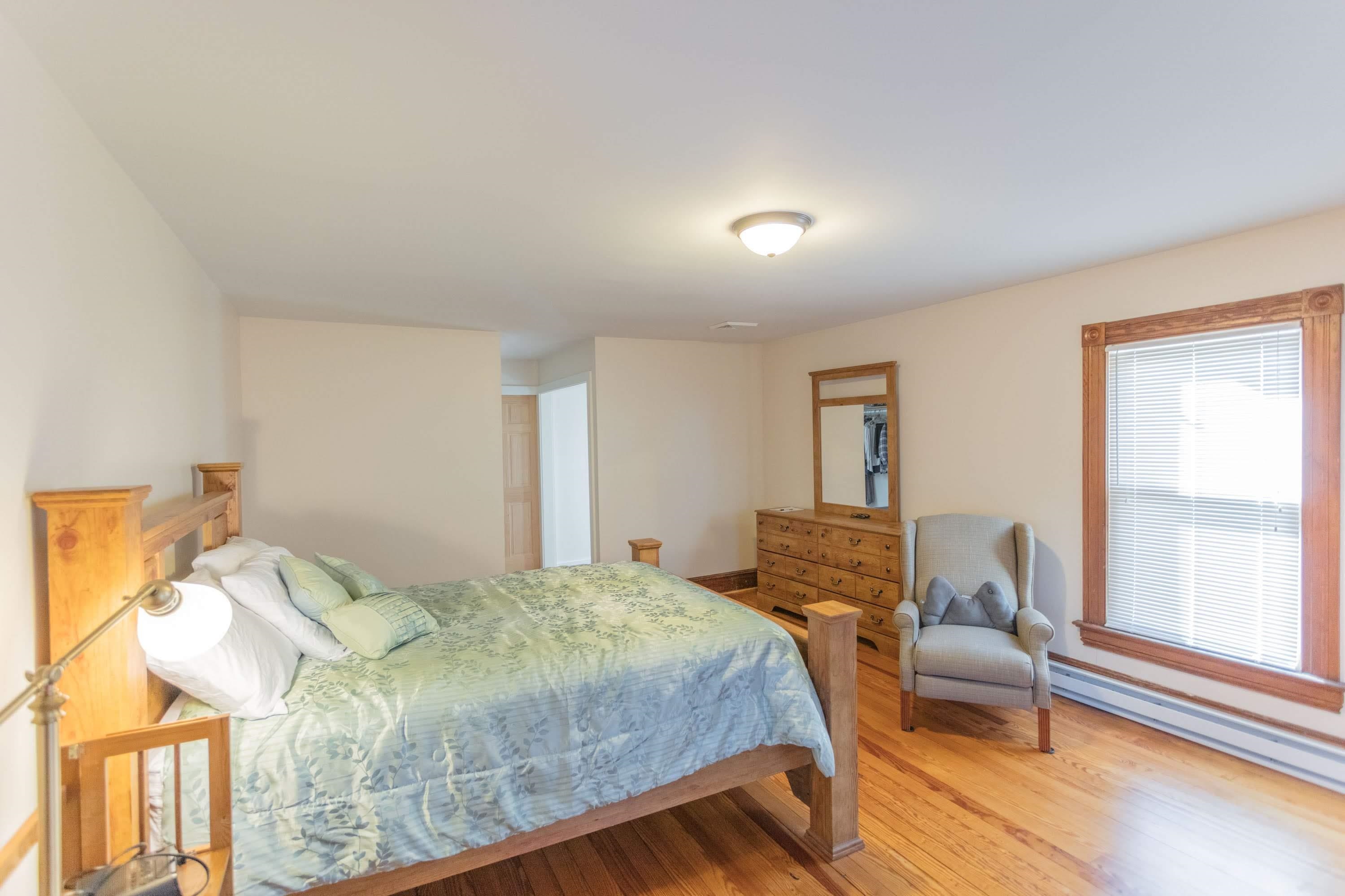 11 Shady Lane Raphine, VA 24472 - Photo 39 of 41 a bedroom with a bed and wooden floor