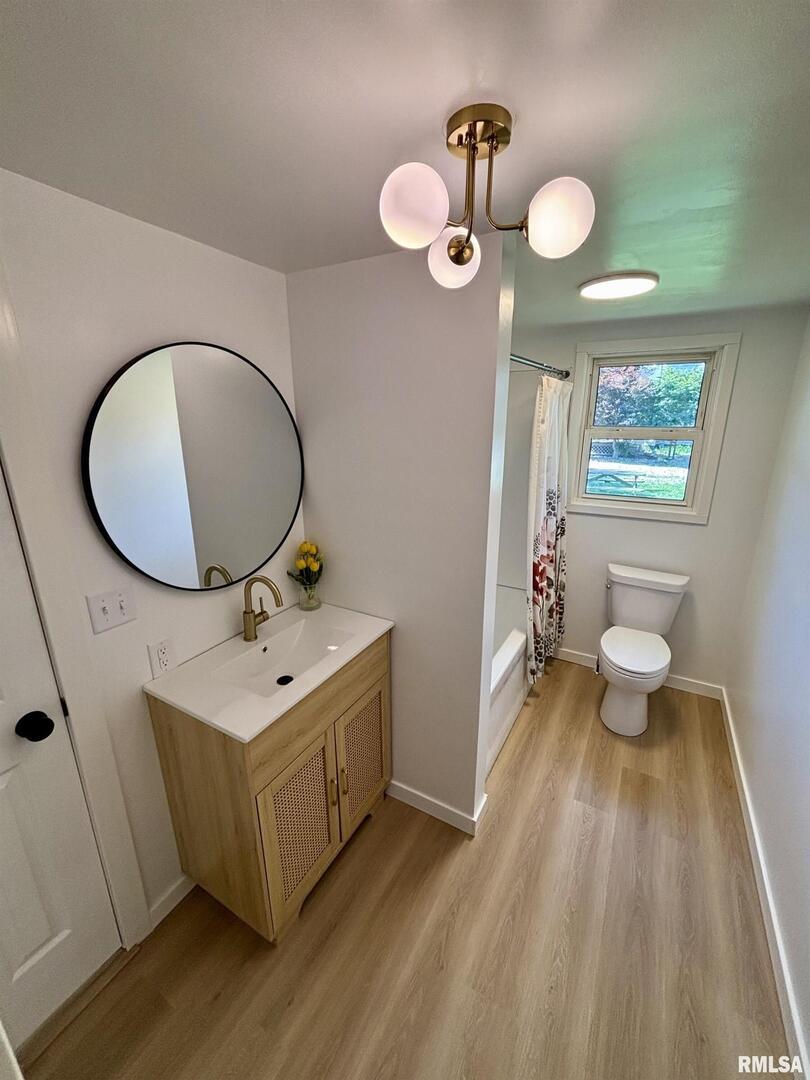 527 South Rotan Street Salem, IL 62881 - Photo 11 of 17 a bathroom with a sink mirror vanity and toilet