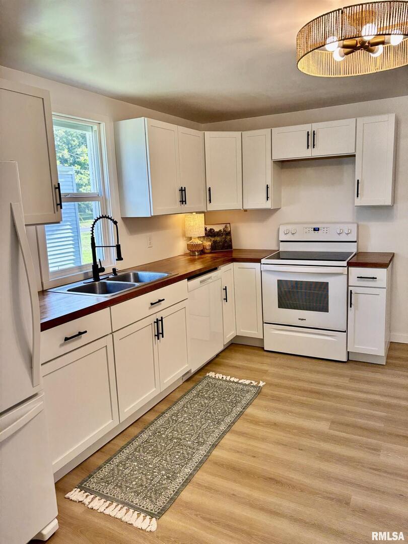 527 South Rotan Street Salem, IL 62881 - Photo 7 of 17 a kitchen with stainless steel appliances granite countertop a sink stove and cabinets