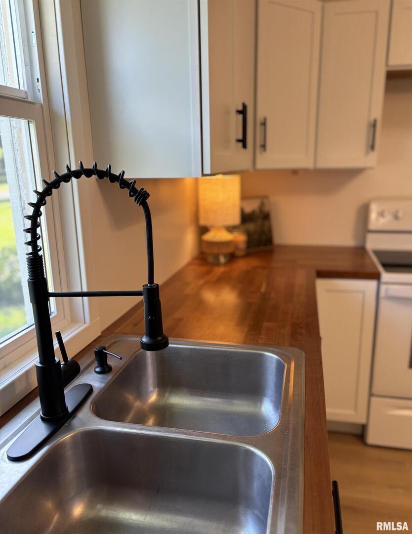 527 South Rotan Street Salem, IL 62881 - Photo 8 of 17 a kitchen with a sink cabinets and a wooden floor