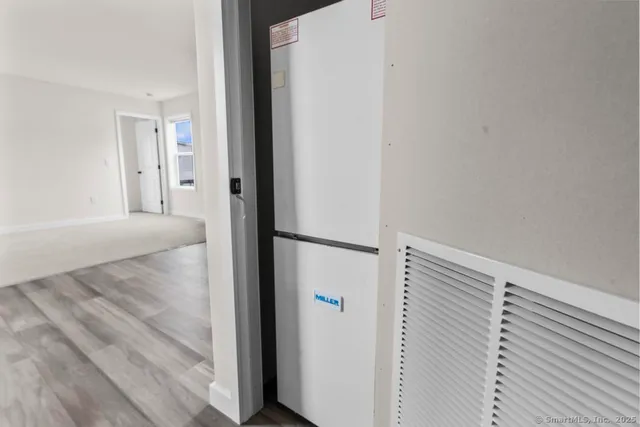 a view of a hallway to rooms