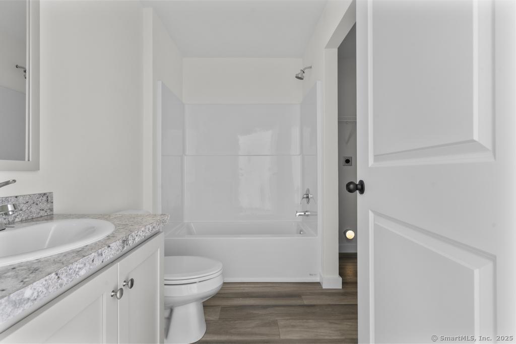 55 Sugar Street, Unit 2 Newtown, CT 06470 - Photo 8 of 19 a bathroom with a granite countertop sink toilet and shower