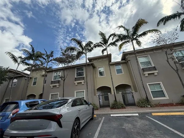 a front view of a house with parking space