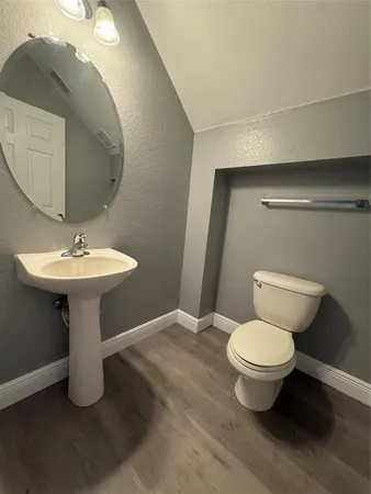 a bathroom with a sink toilet and mirror