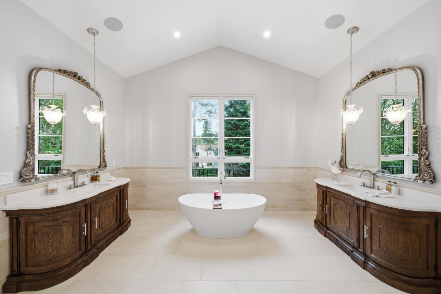 830 Bromfield Road San Mateo, CA 94402 - Photo 39 of 93 a bathroom with a double vanity sink a two mirror a window a bathtub and a window
