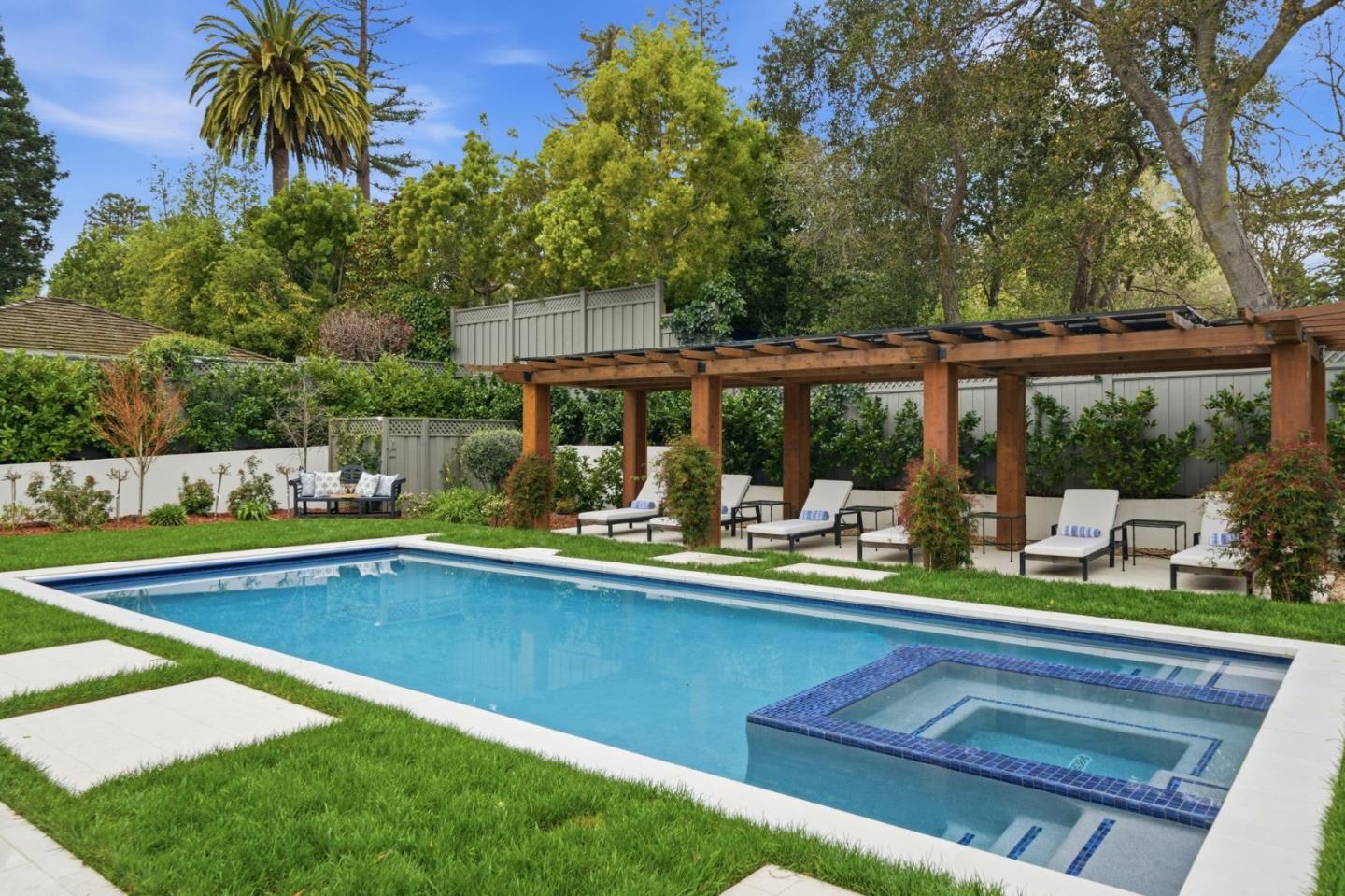830 Bromfield Road San Mateo, CA 94402 - Photo 67 of 93 a view of swimming pool with a table and chairs under an umbrella