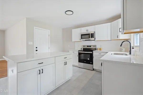 a kitchen with sink cabinets and stainless steel appliances