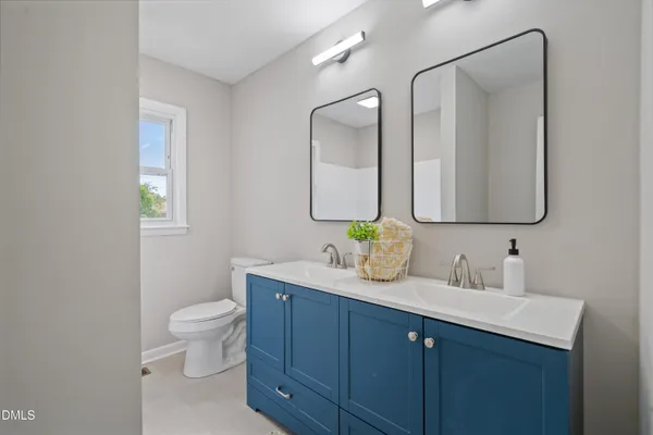 a bathroom with 2 sink and a mirror