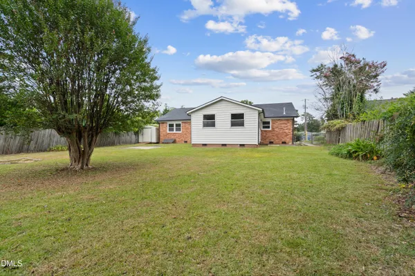 a view of a house with a yard and tree
