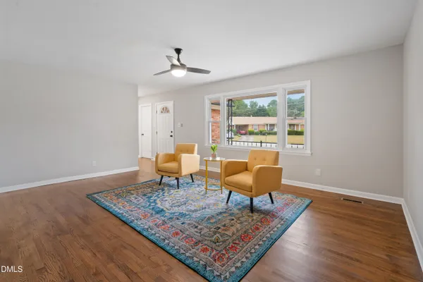 a living room with furniture rug and window