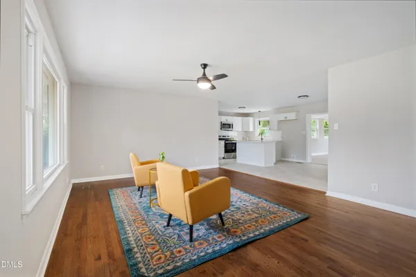 a living room with dining room and wooden floor