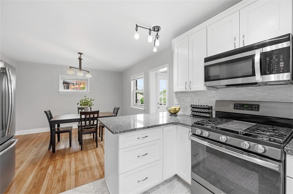 405 Shadyhill Road Pittsburgh, PA 15205 - Photo 13 of 34 a kitchen with granite countertop cabinets stainless steel appliances and dining table