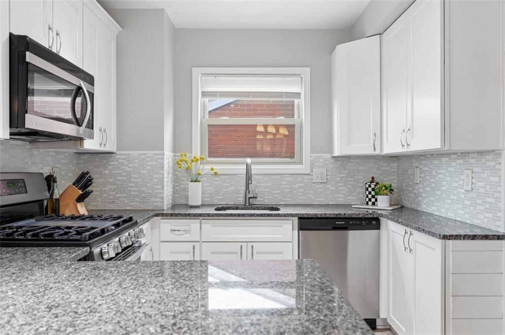 405 Shadyhill Road Pittsburgh, PA 15205 - Photo 14 of 34 a kitchen with stainless steel appliances a sink stove and cabinets