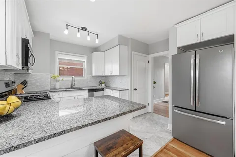 a kitchen with a refrigerator a sink and dishwasher