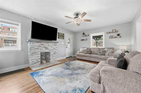 a living room with fireplace furniture and a flat screen tv