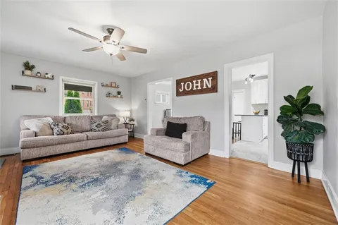 a living room with furniture and a potted plant