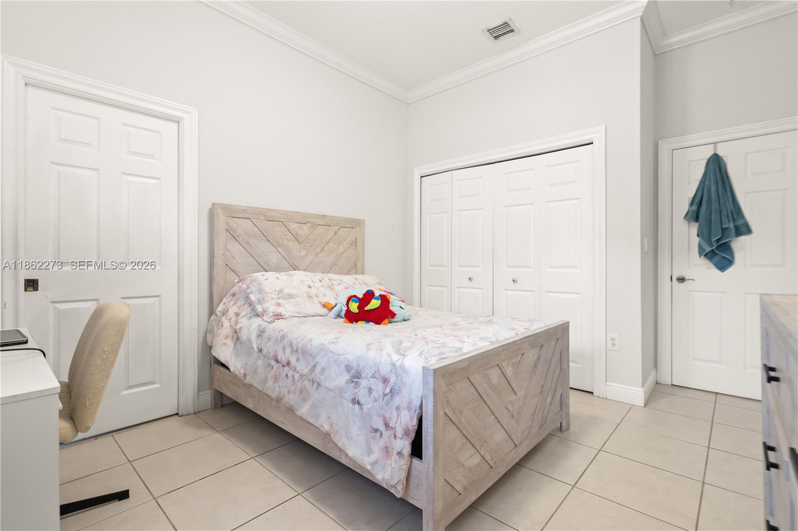 8366 Southwest 193rd Street Cutler Bay, FL 33157 - Photo 16 of 20 a bedroom with a bed and a dresser