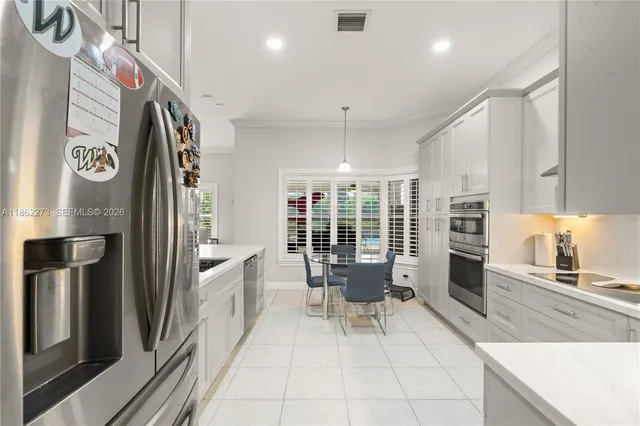 a large white kitchen with a large window