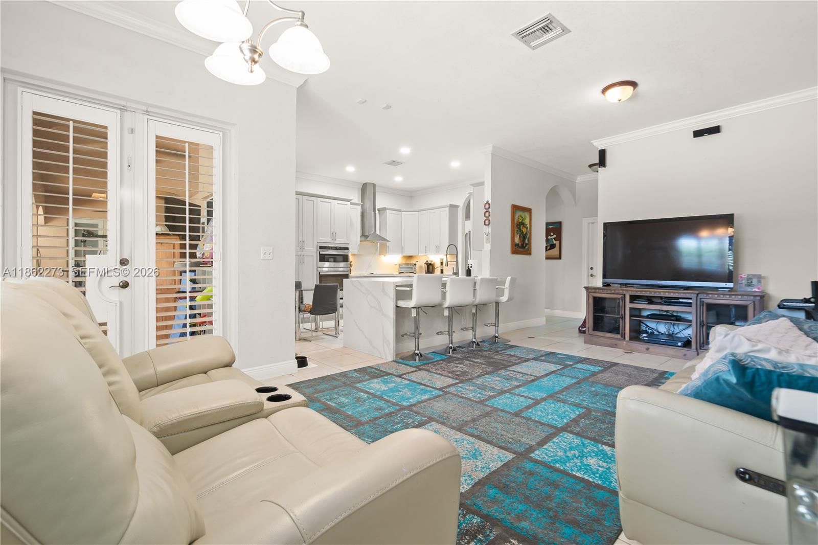 8366 Southwest 193rd Street Cutler Bay, FL 33157 - Photo 8 of 20 a living room with furniture and a flat screen tv
