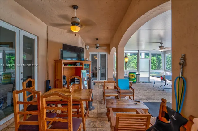 a living room with fireplace furniture and a large window
