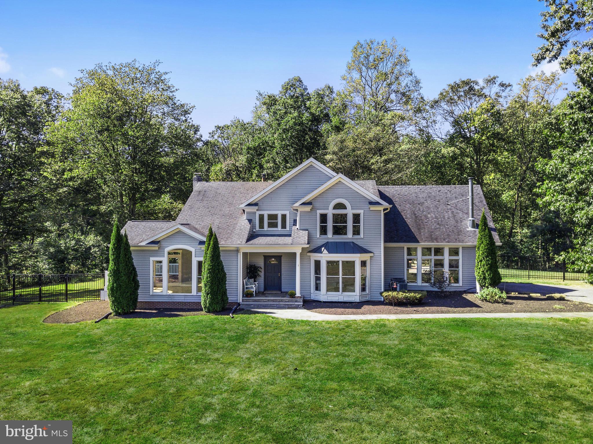 3444 Woodbine Road Woodbine, MD 21797 - Photo 11 of 78 a front view of a house with a garden