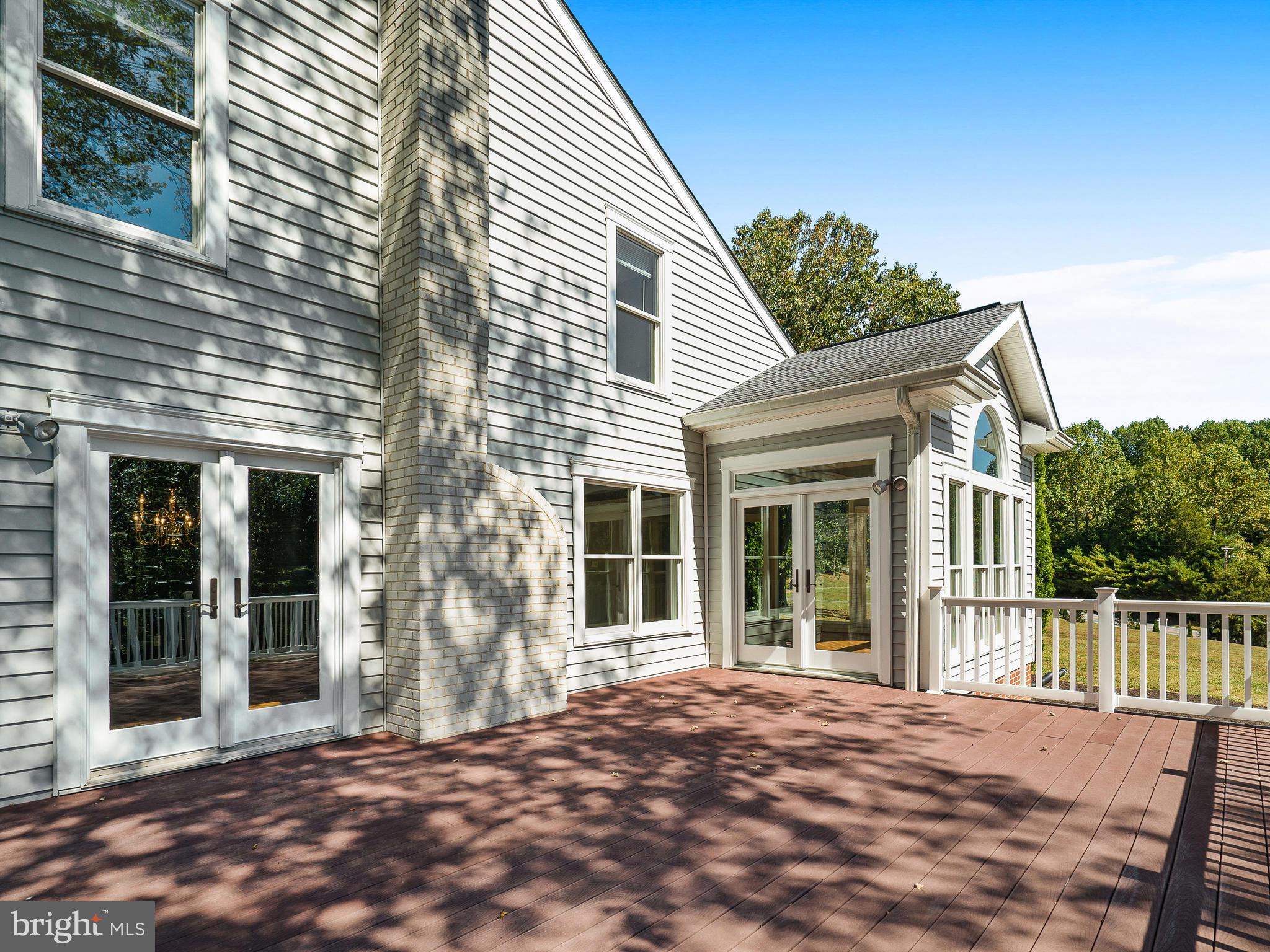 3444 Woodbine Road Woodbine, MD 21797 - Photo 33 of 78 a view of a house with a wooden deck