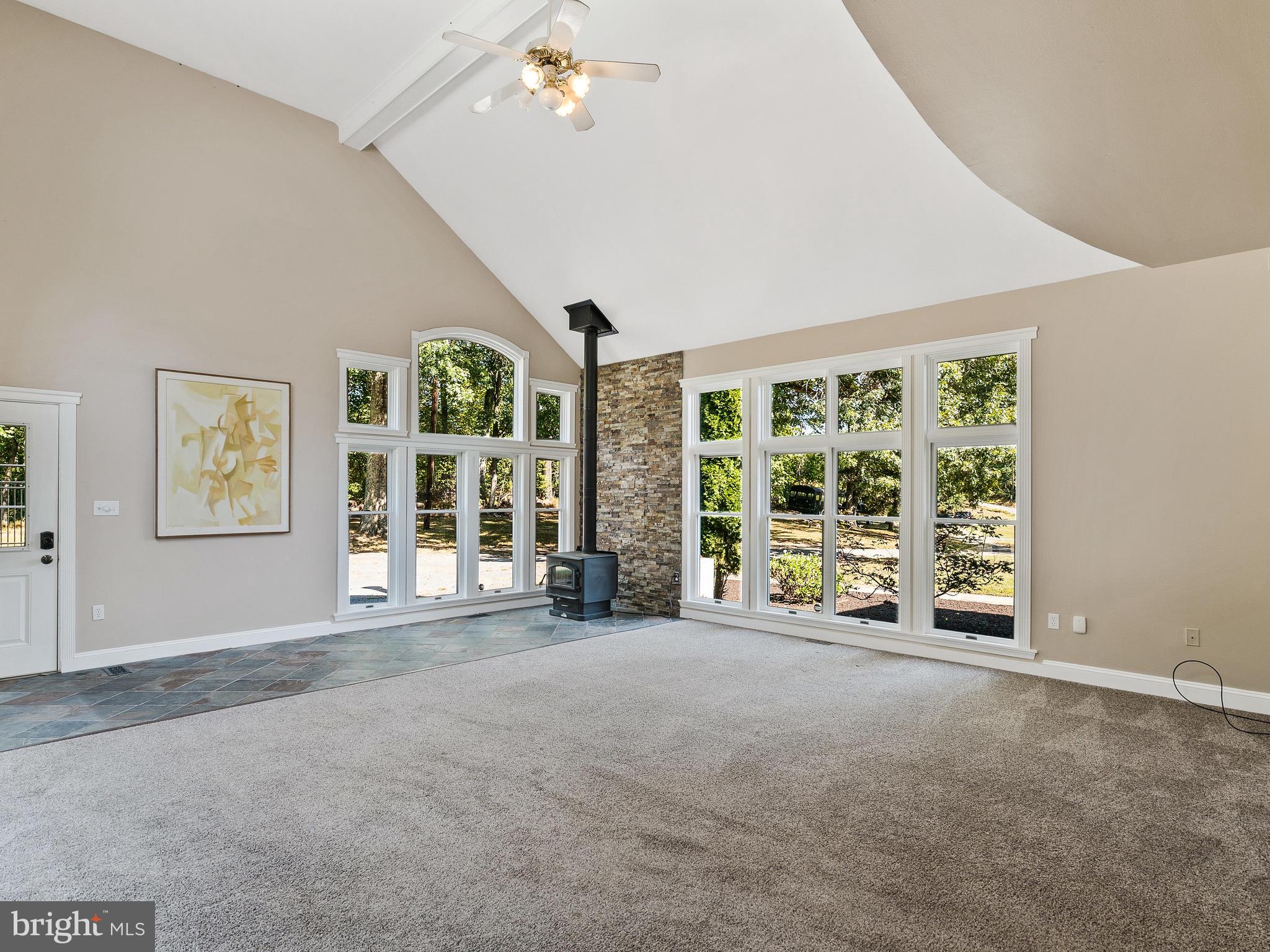 3444 Woodbine Road Woodbine, MD 21797 - Photo 39 of 78 a view of an empty room with a fireplace and a large window