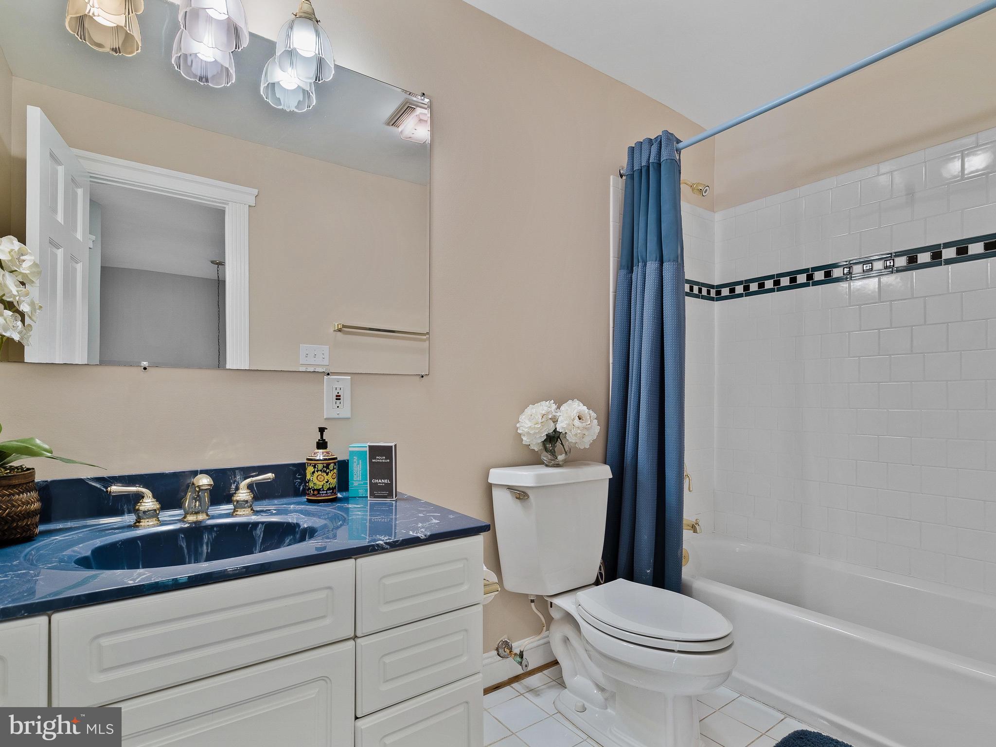 3444 Woodbine Road Woodbine, MD 21797 - Photo 56 of 78 a bathroom with a granite countertop sink a toilet a mirror and shower