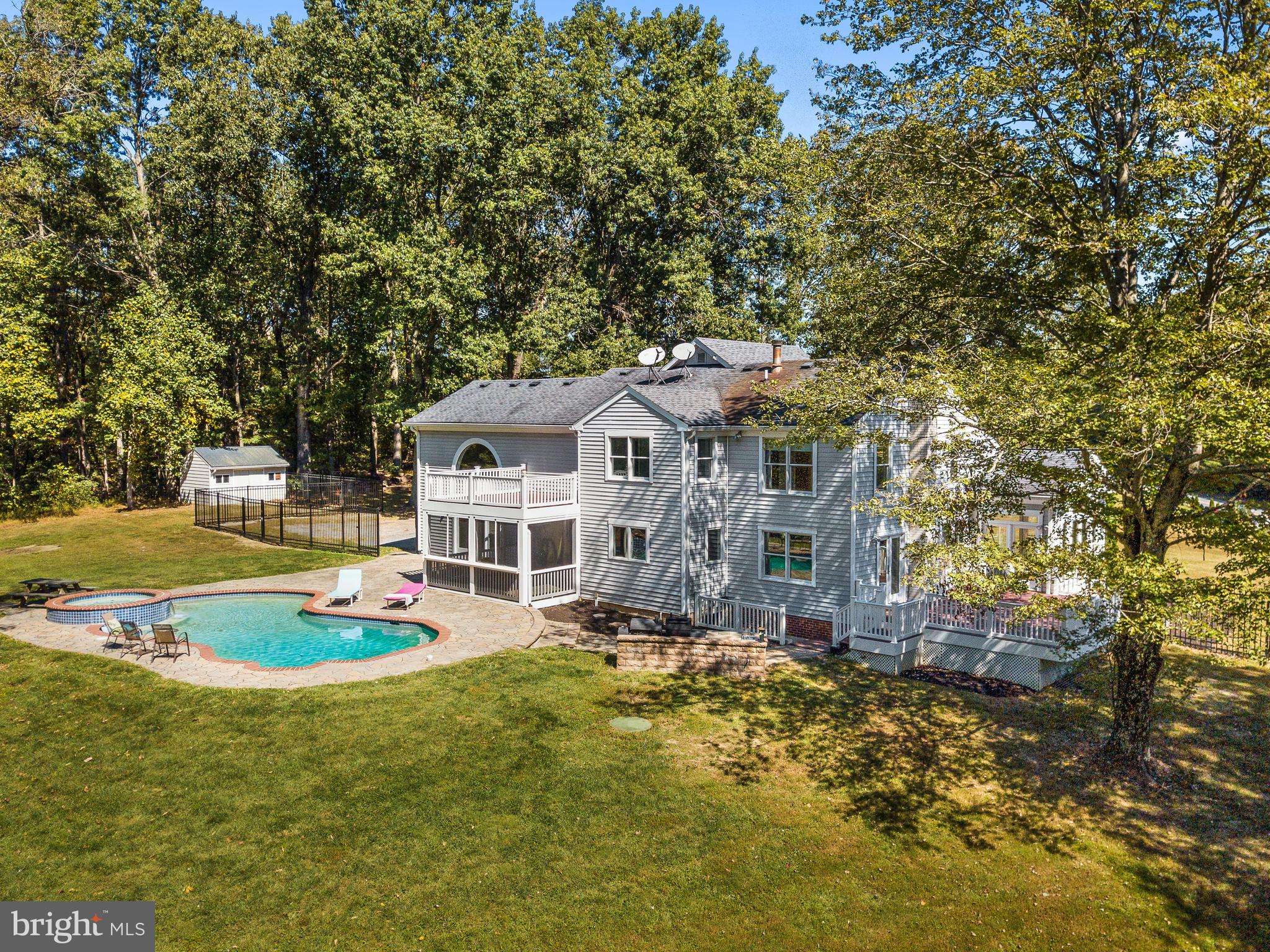 3444 Woodbine Road Woodbine, MD 21797 - Photo 8 of 78 a front view of a house with a yard table and chairs