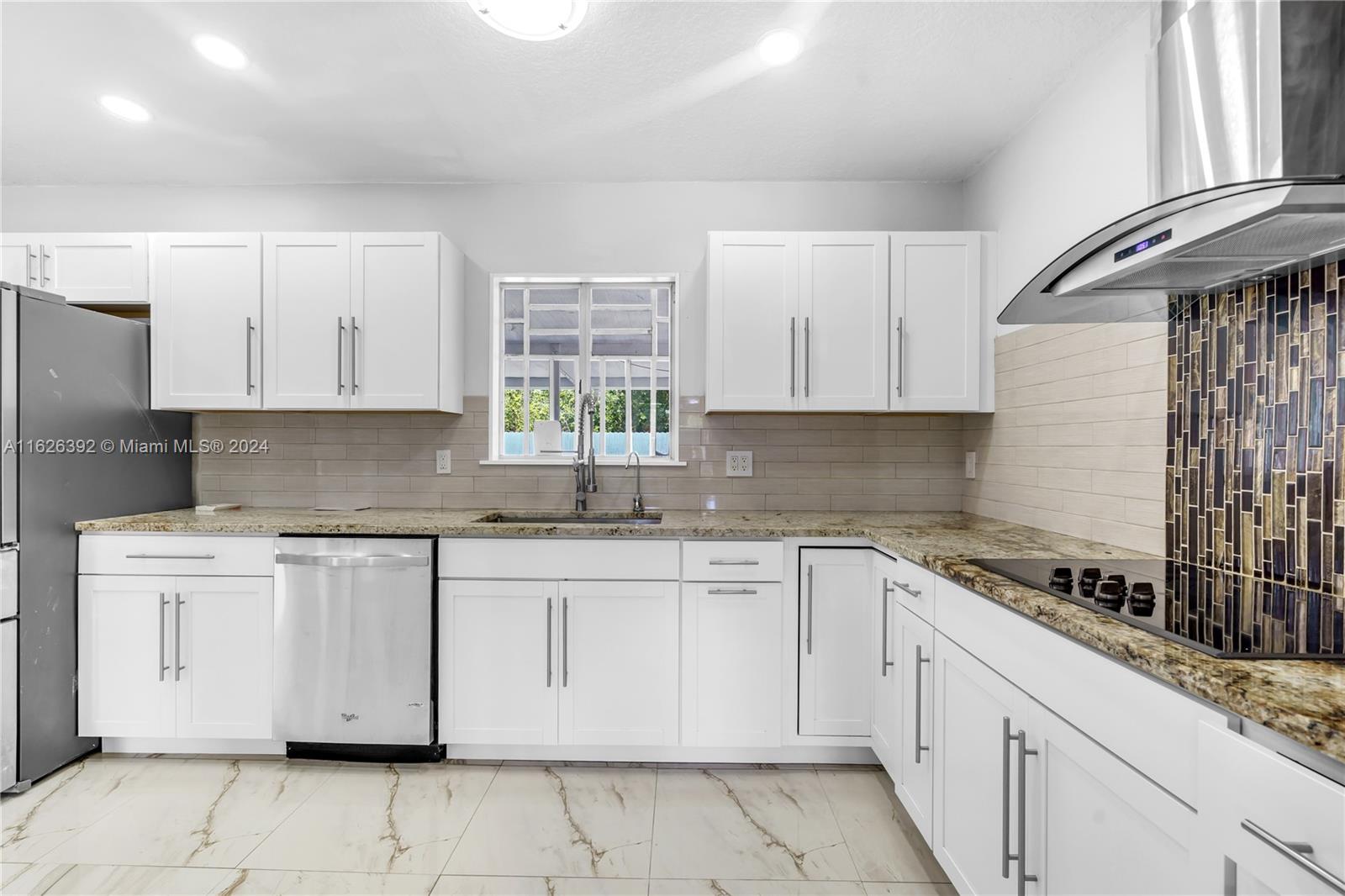 Goulds Miami, FL 33170 - Photo 15 of 36 a kitchen with granite countertop white cabinets and white appliances
