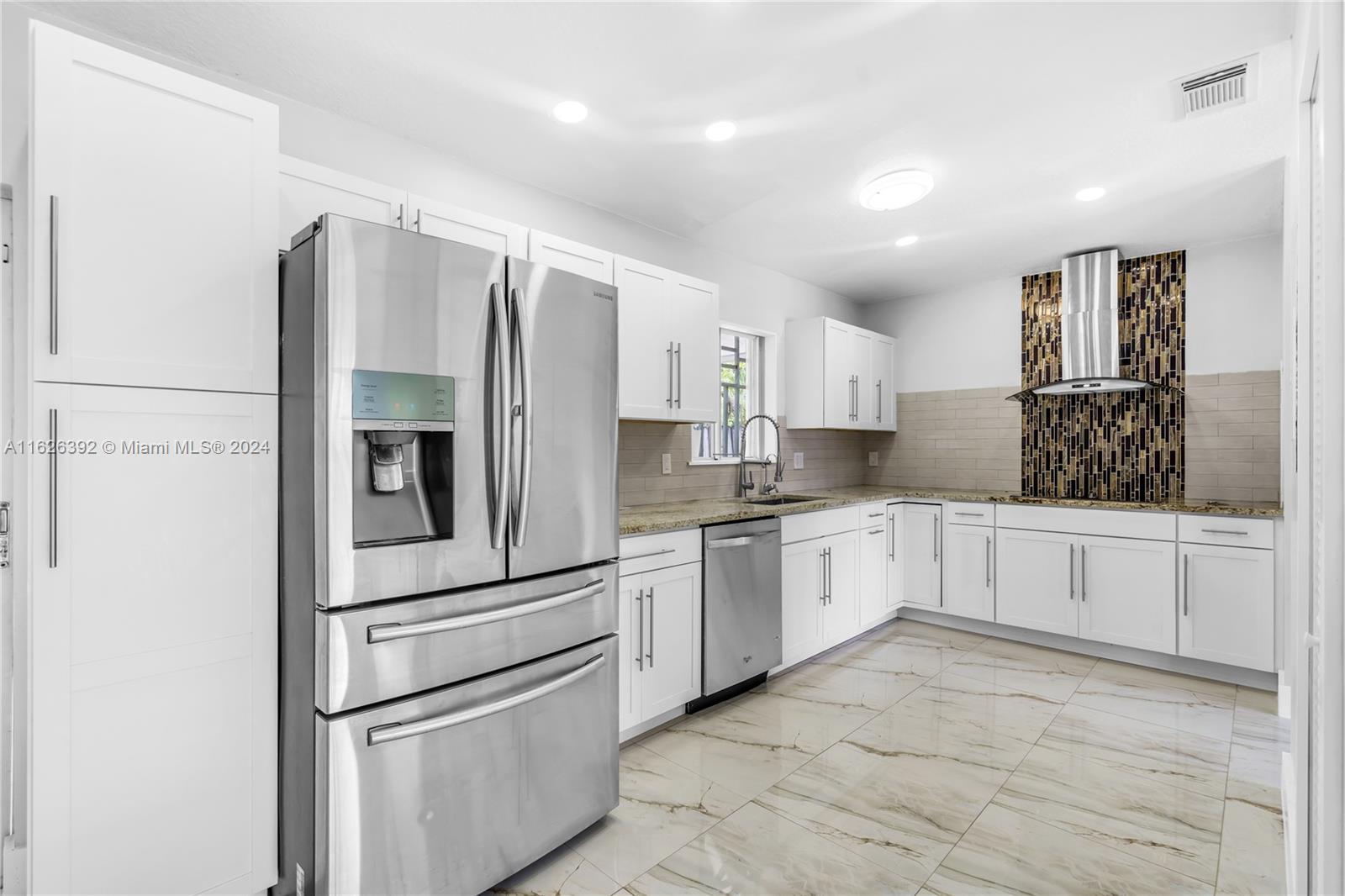 Goulds Miami, FL 33170 - Photo 16 of 36 a kitchen with stainless steel appliances a refrigerator sink and cabinets