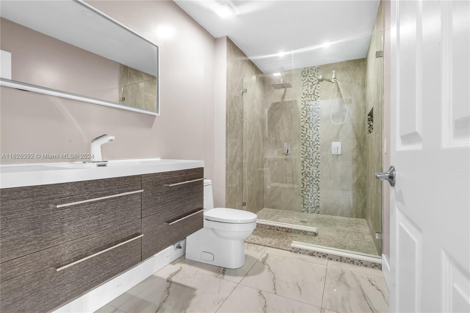 Goulds Miami, FL 33170 - Photo 17 of 36 a bathroom with a sink toilet a mirror and shower