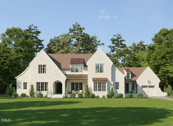 a front view of a house with a garden and trees