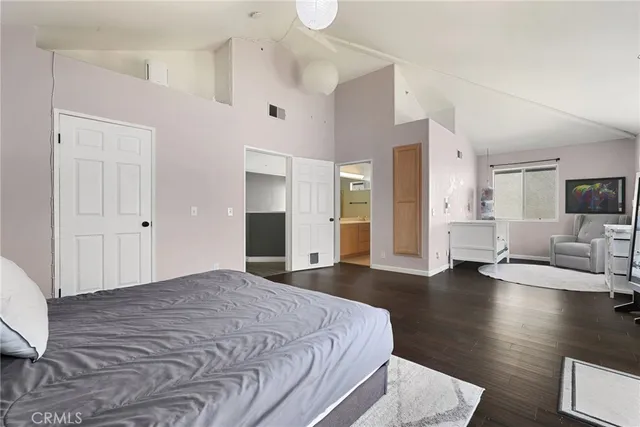 a spacious bedroom with a bed and couch