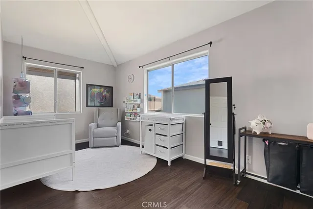 a kitchen with a refrigerator and white cabinets