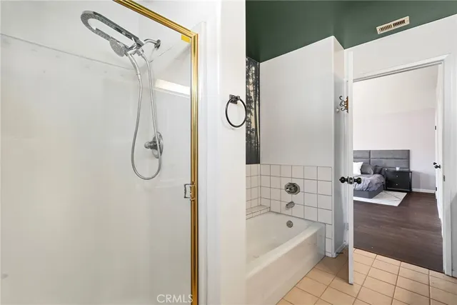 a bathroom with a tub shower and a sink