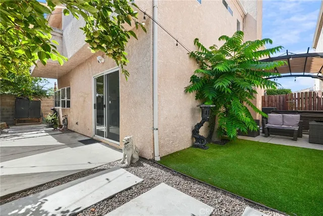 a view of backyard of a house with a patio