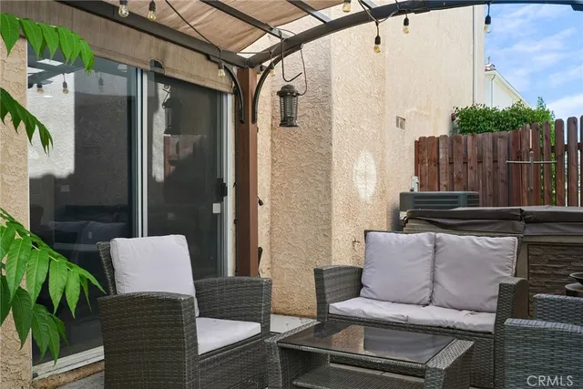 a balcony with table and chairs