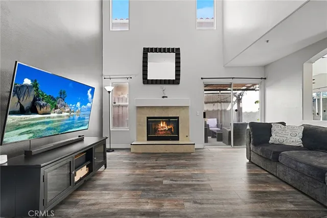 a living room with fireplace furniture and a flat screen tv