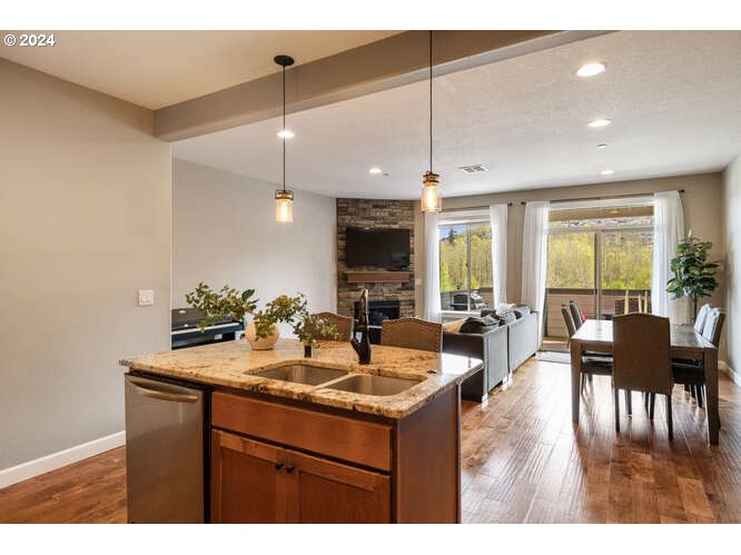 4307 Northwest Sage Loop Camas, WA 98607 - Photo 21 of 40 a kitchen with a dining table chairs with granite countertop couches and a coffee table