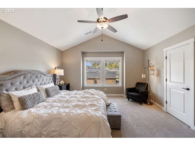4307 Northwest Sage Loop Camas, WA 98607 - Photo 23 of 40 a bedroom with a bed and a chandelier