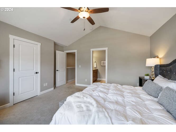 4307 Northwest Sage Loop Camas, WA 98607 - Photo 25 of 40 a bedroom with a bed and a chandelier