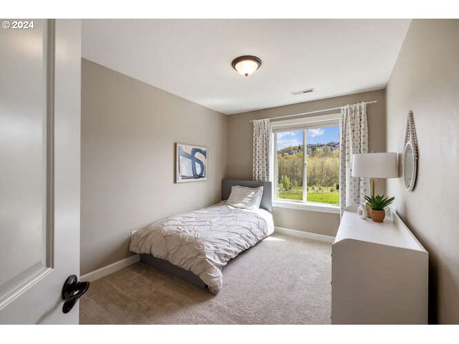 4307 Northwest Sage Loop Camas, WA 98607 - Photo 31 of 40 a bedroom with a bed and a large window