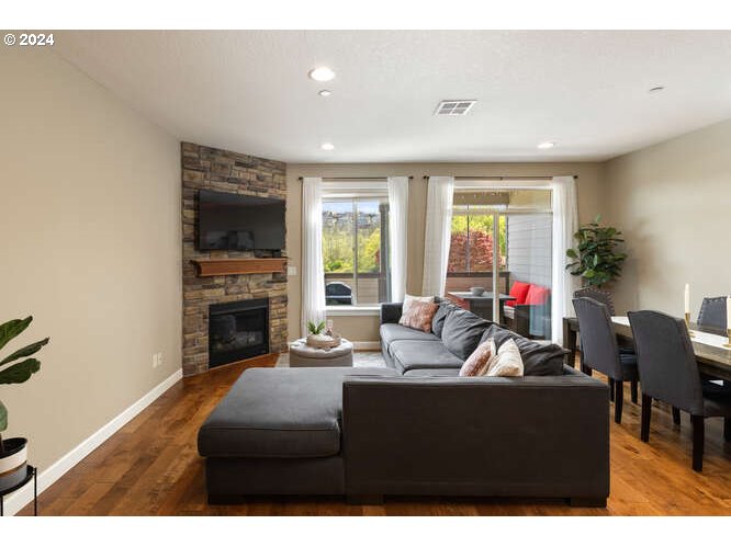 4307 Northwest Sage Loop Camas, WA 98607 - Photo 6 of 40 a living room with furniture a fireplace and a dining room