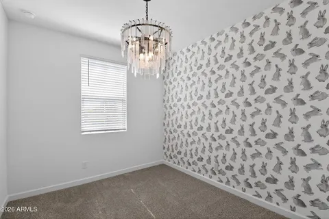 en empty room with windows and ceiling fan