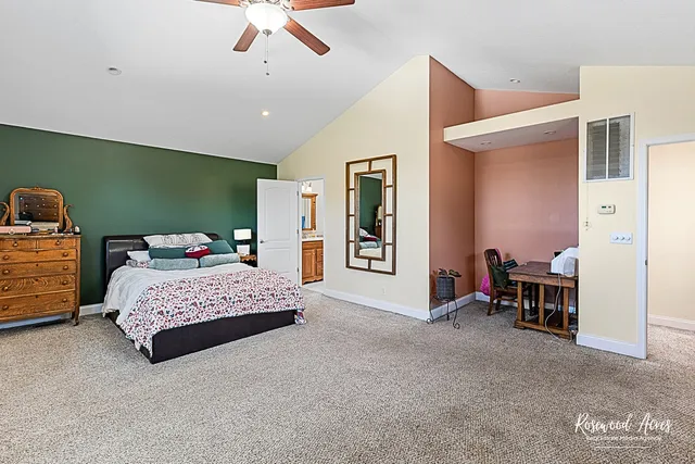 a spacious bedroom with a bed and a chandelier